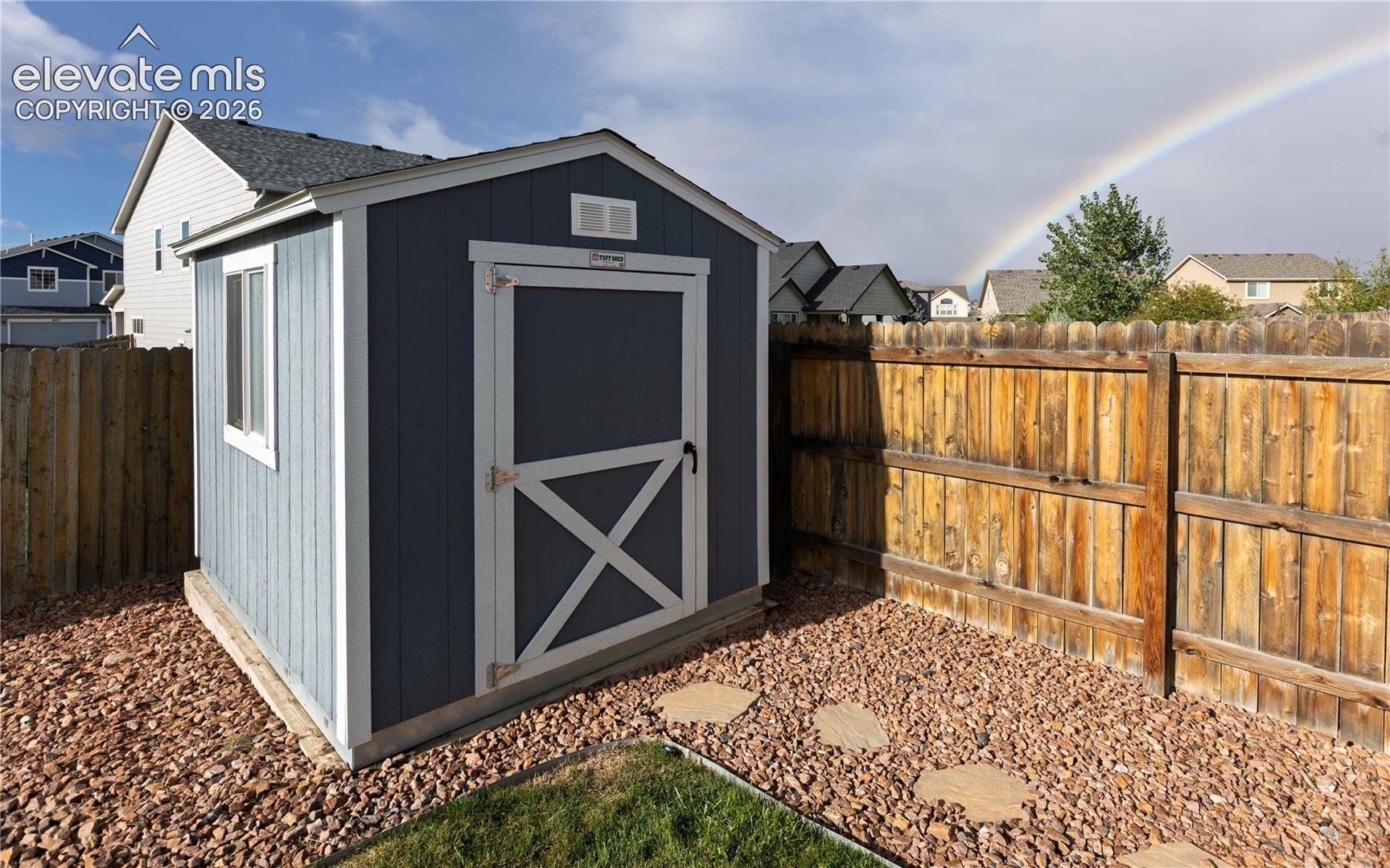 Well kept storage shed.
Not AI.. photographer caught the rainbow