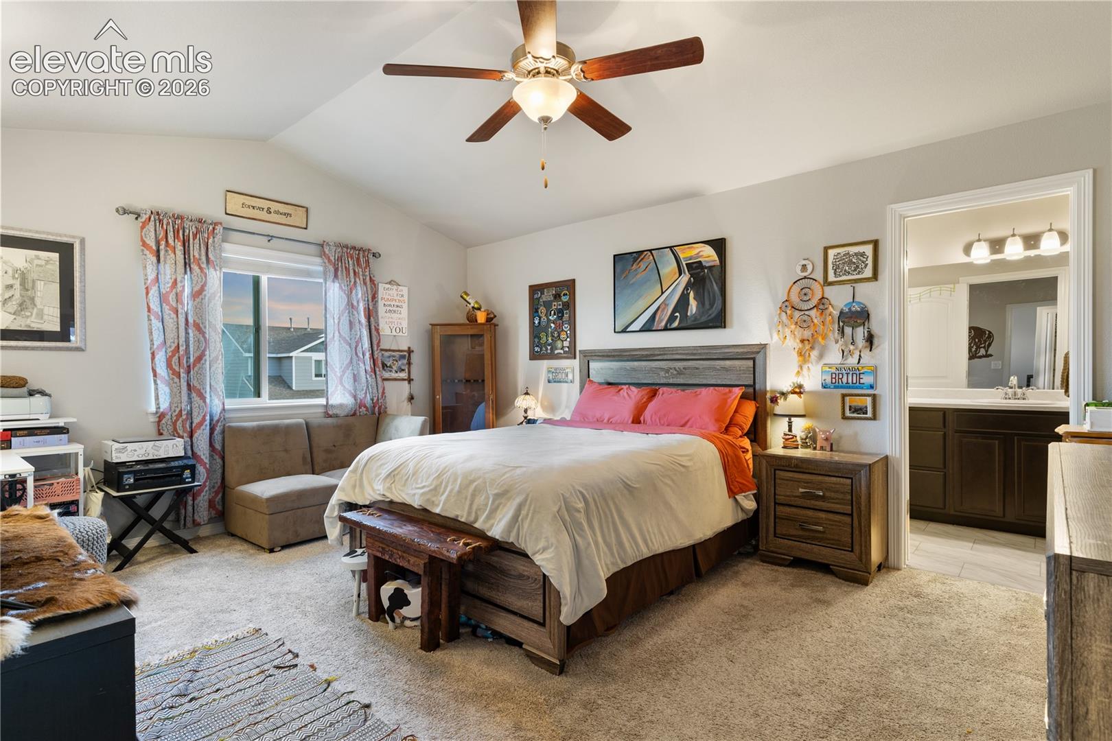 Spacious bedroom featuring vaulted ceilings
