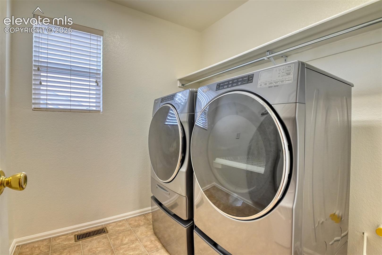 Utility space featuring a window with blinds
