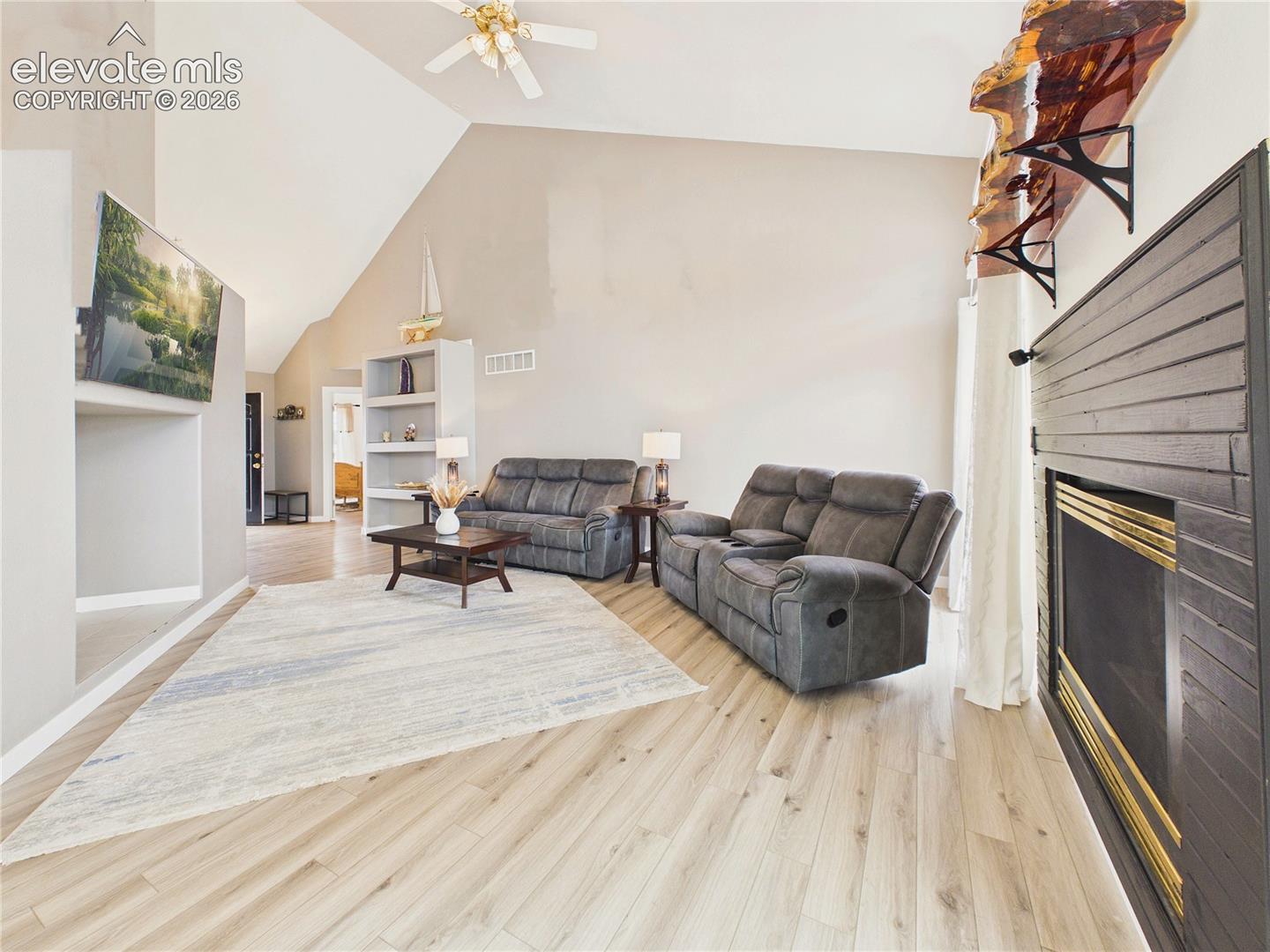 Vaulted ceilings and abundant natural light enhance the spacious feel of this comfortable gathering area.