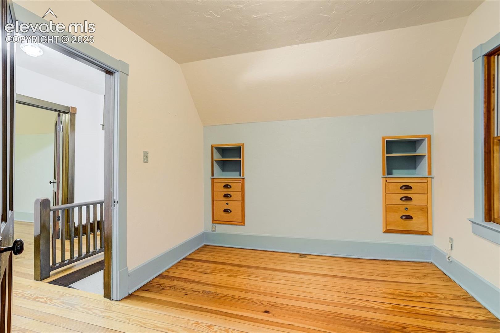One of 2 upper level bedrooms with built in storage!