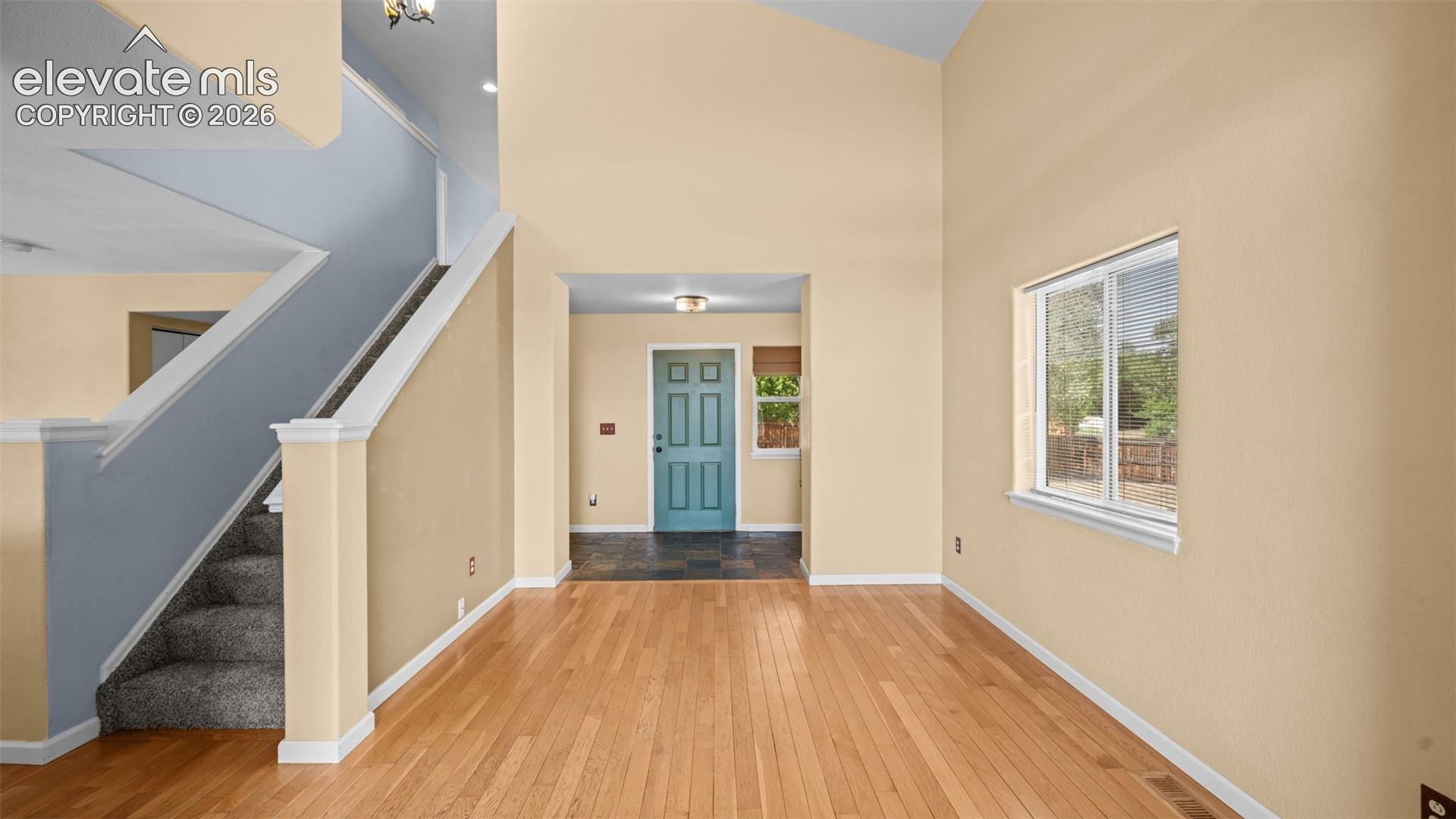 Wide entry area with closet space and opening in to two-story living area