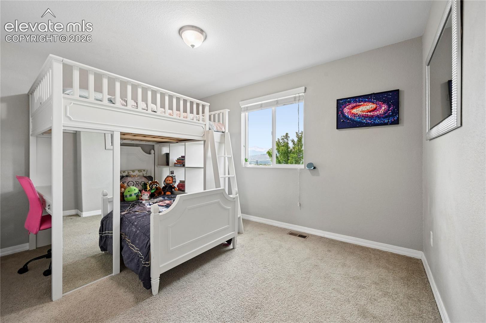 Bedroom #2 of 5 is upstairs, and is one of the windows that enjoys the same Pikes Peak views as you can from your front porch.