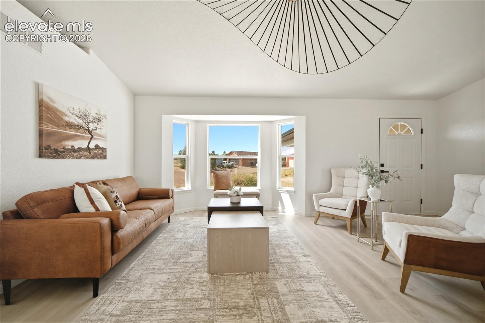 Living room featuring light wood-finish flooring and white painted walls
