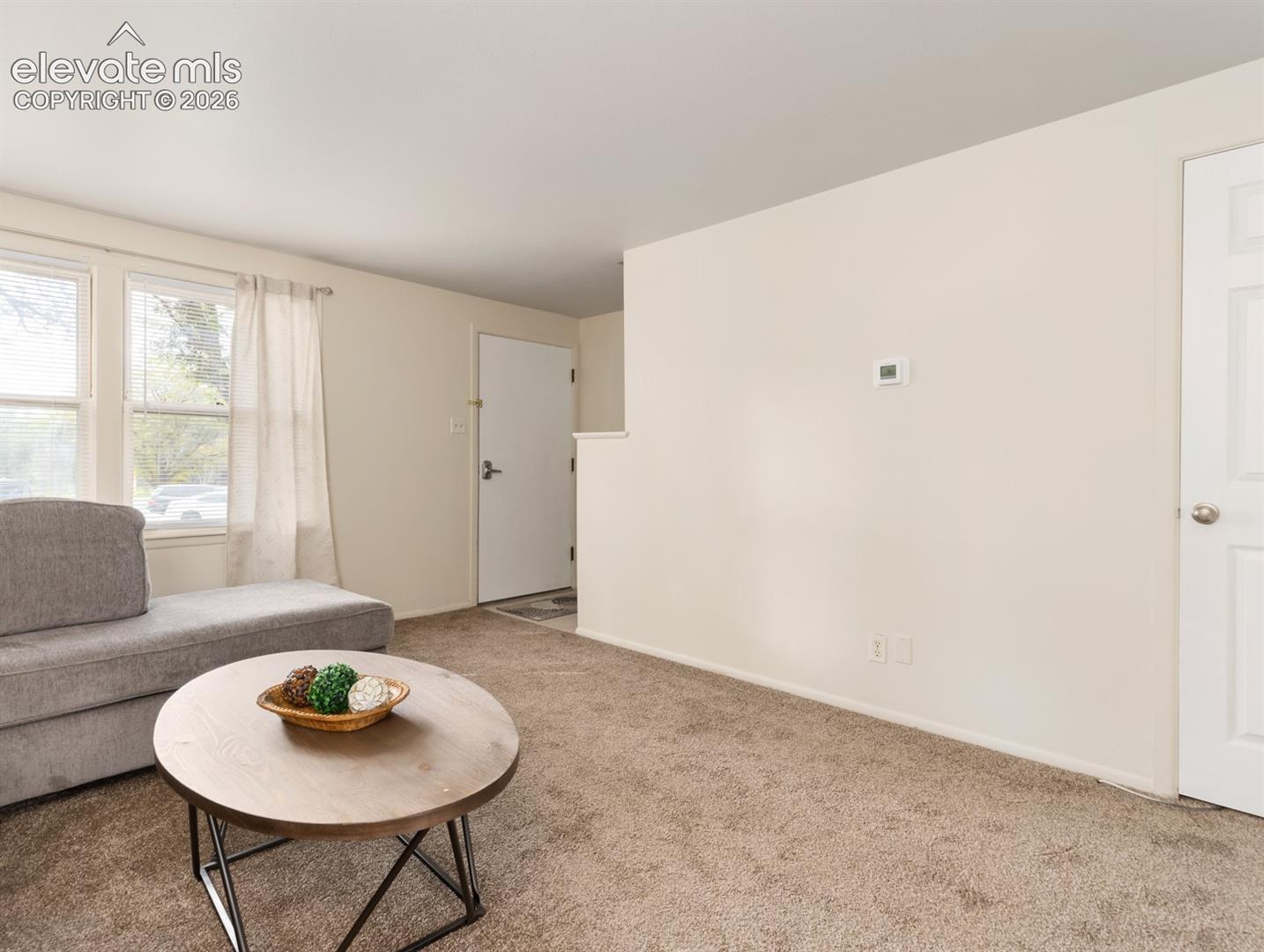 Full size living room has an L shaped sofa and a smart tv on the wall (not in photo)