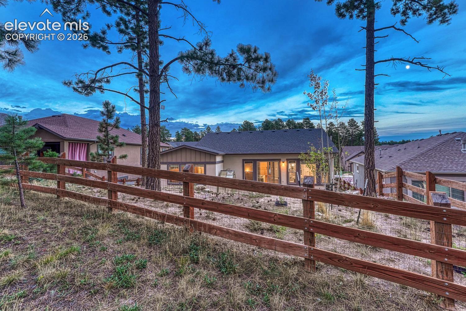 fenced in backyard that backs to small common area