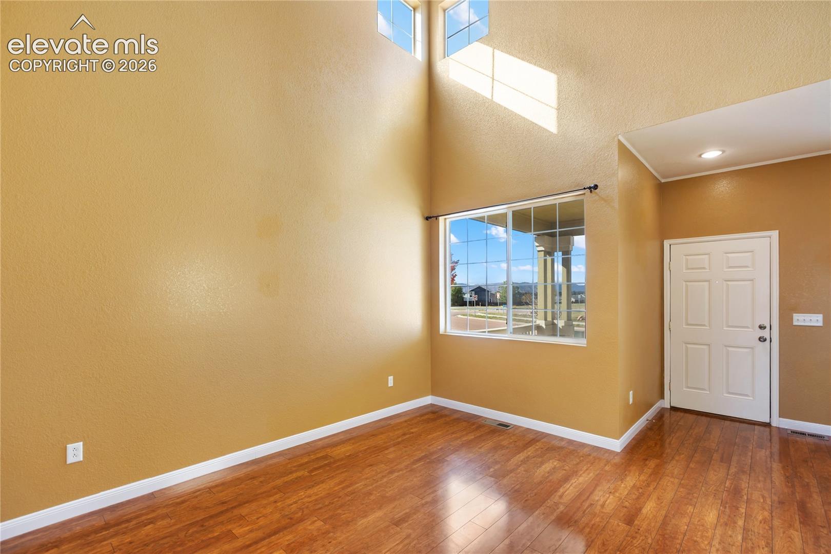 High vaulted ceilings with high windows creating a grand entrance and atmosphere. Wood lvp floors throughout add to the luxury feel.