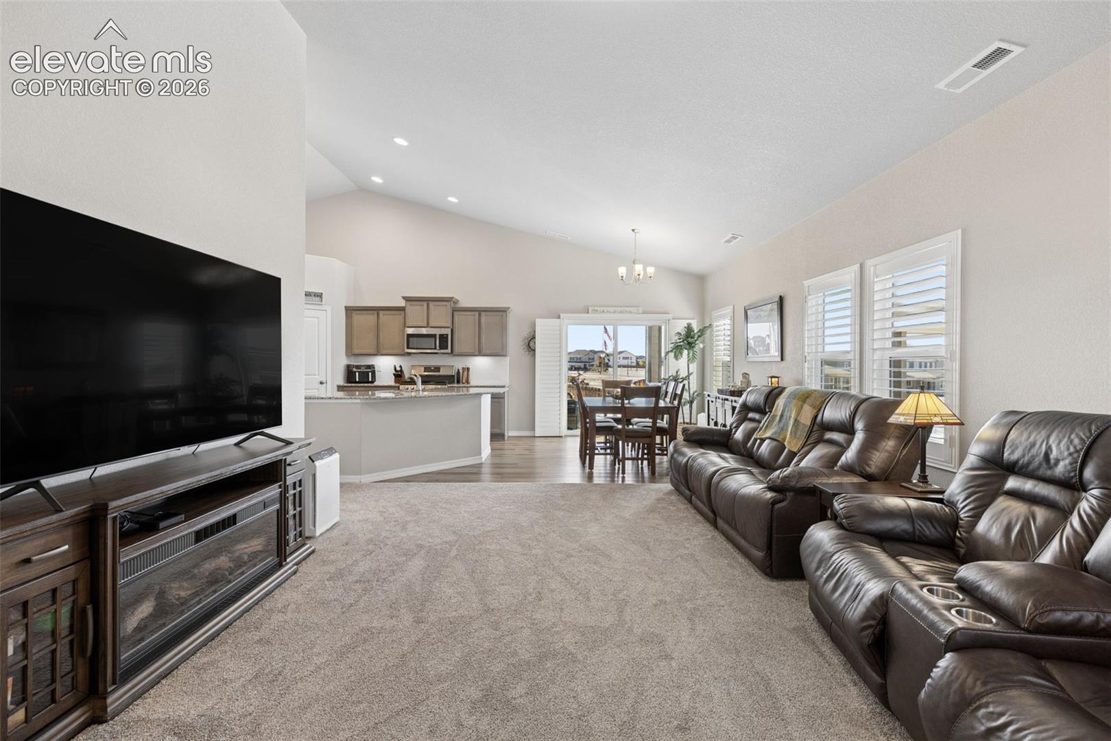 Vaulted ceilings and neutral colors show off this sunny space for entertaining and relaxing.