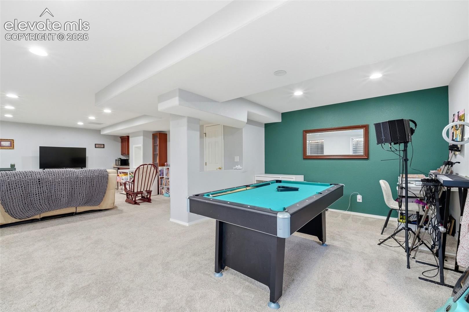 Open-concept recreation room featuring recessed lighting, a built-in pool table, and soft carpet flooring