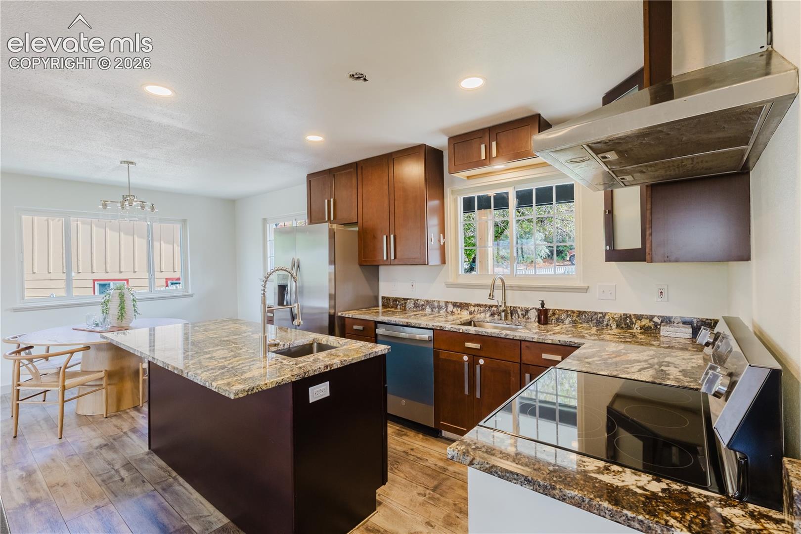 Kitchen featuring wood-finish flooring, recessed lighting, and a stainless steel appliance suite