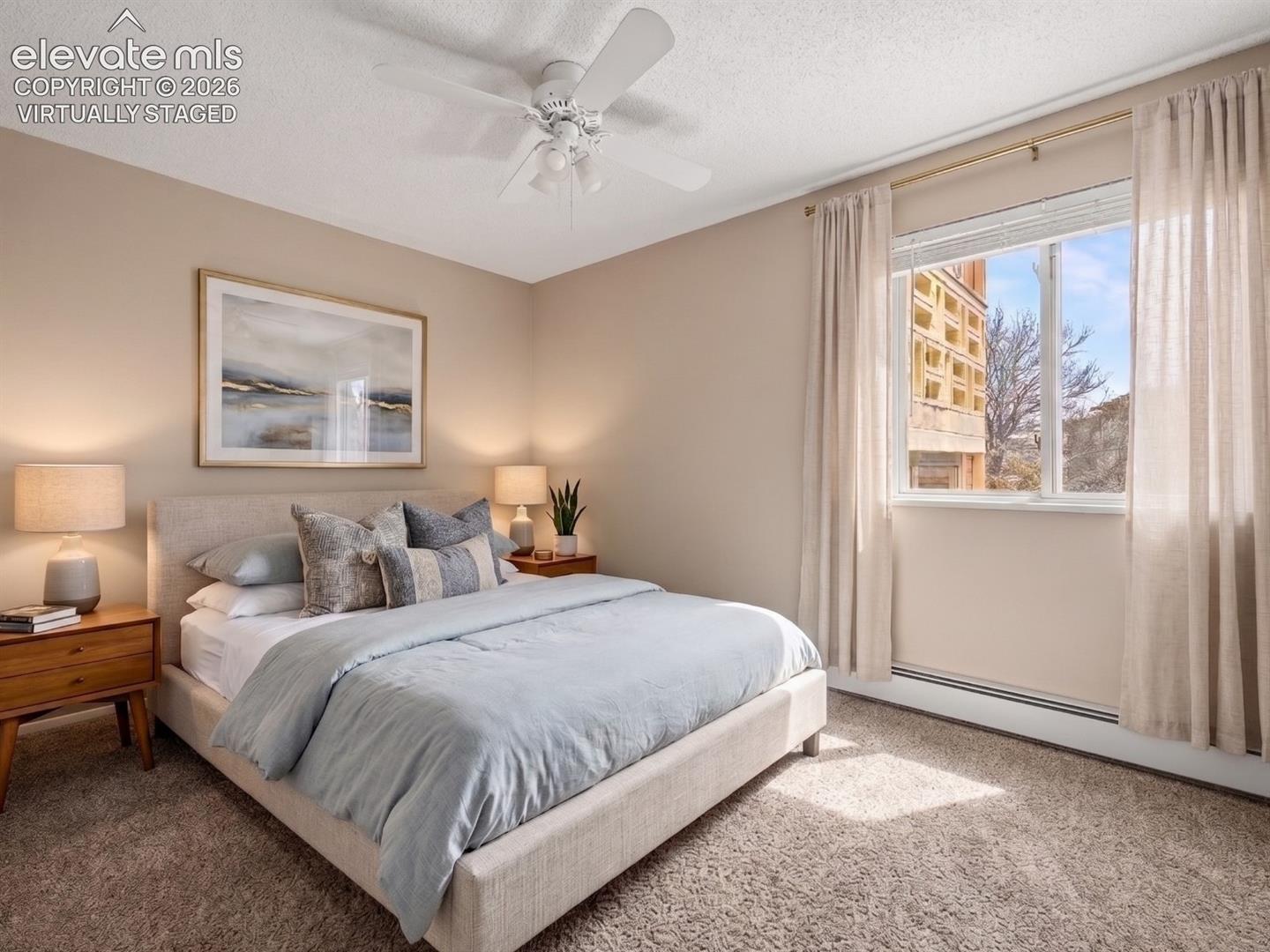 virtually staged Carpeted room with a ceiling fan and large window