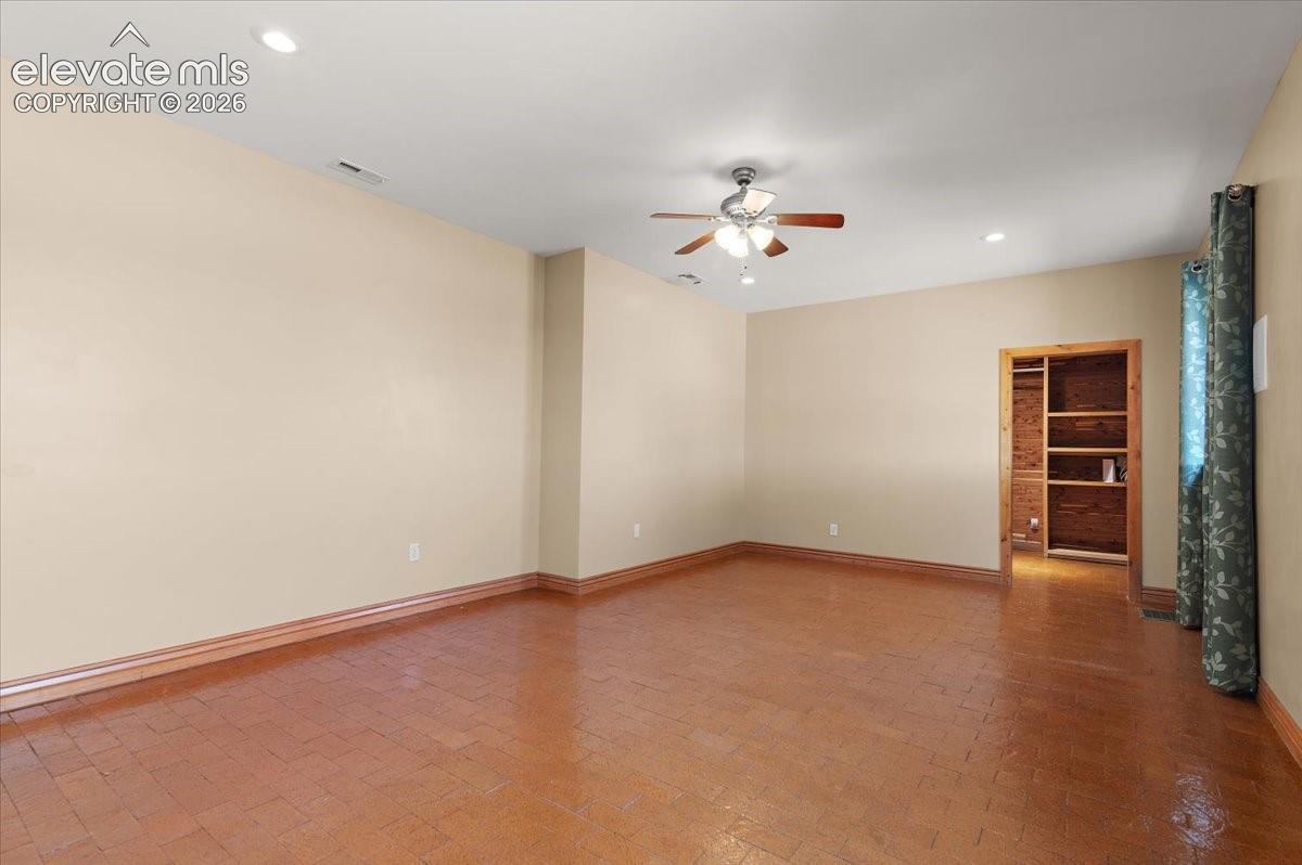 14 ft. X 21 ft. primary bedroom with access to walk in 7 ft. X 13 ft. closet. In wall speakers and ceiling fan