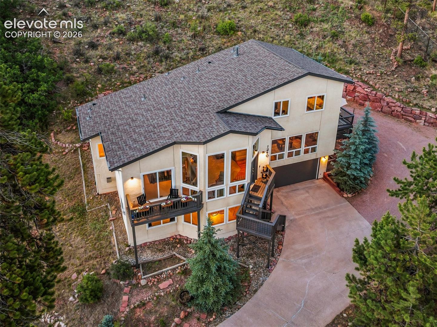 Wake up to breathtaking, unobstructed views of Pikes Peak from this beautifully updated mountain home on a private 0.77-acre lot in Woodland Park. Offering 3,202 square feet, 4 bedrooms, 4 bathrooms, and an attached 2-car garage, this property combines spectacular scenery with spacious living and thoughtful updates throughout. Designed to capture the beauty of its surroundings, the home features expansive windows that fill the interior with natural light while showcasing unmatched views of Pikes Peak from multiple living spaces. Nearly every window has been replaced, and the new windows include a transferable warranty, providing added value and peace of mind. The spacious floor plan offers room for everyone, with multiple gathering spaces, a loft, and a finished flex room ideal for a home gym, office, or hobby room. Fresh interior paint in several areas creates a bright, refreshed feel, while recent improvements—including a new oven, new water heater, new primary suite patio doors, ceiling fans throughout the home, and a new garage door opener and main spring—make this home move-in ready. Step outside to enjoy the freshly sanded and painted decks, where you'll have a front-row seat to Colorado's stunning mountain scenery. Exterior doors and trim have been freshly painted, outdoor lighting has been updated, and custom-built garage shelving provides excellent storage and organization. Located just minutes from the heart of Woodland Park, you'll enjoy convenient access to local shopping, restaurants, parks, and year-round recreation while still experiencing the privacy and tranquility of mountain living. If you've been looking for a home that offers incredible views, extensive updates, and an unbeatable location, this exceptional property is ready to welcome you home.