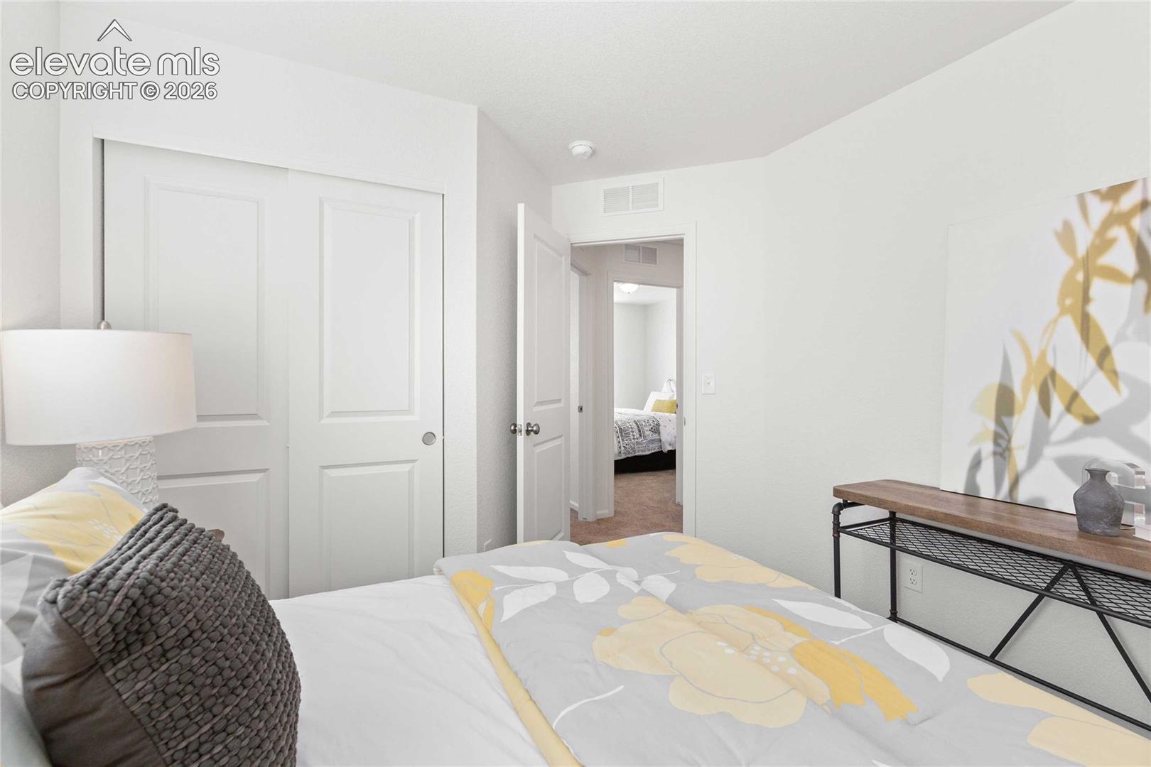 White interior walls and ceiling, two-panel closet doors, and wood-finish flooring
*photos  of a model home*