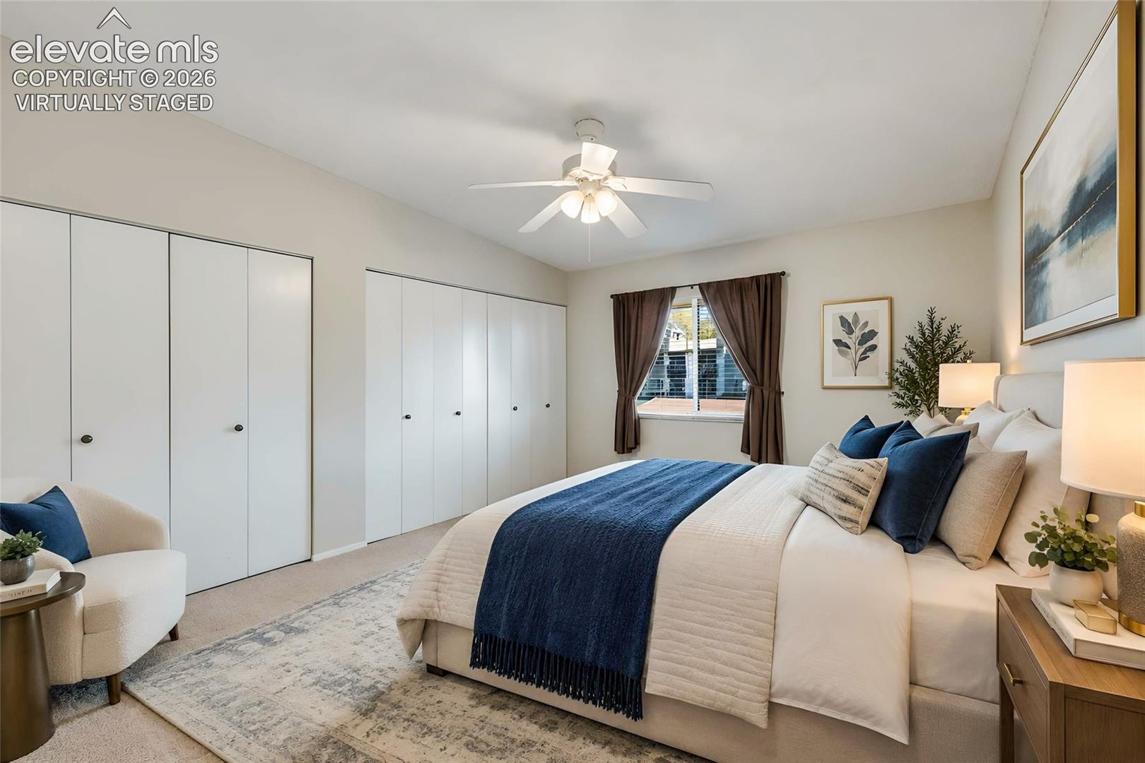 virtually staged. 
Spacious room featuring neutral carpeting, dual floor-to-ceiling bi-fold door closets, and a central ceiling fan with integrated lighting