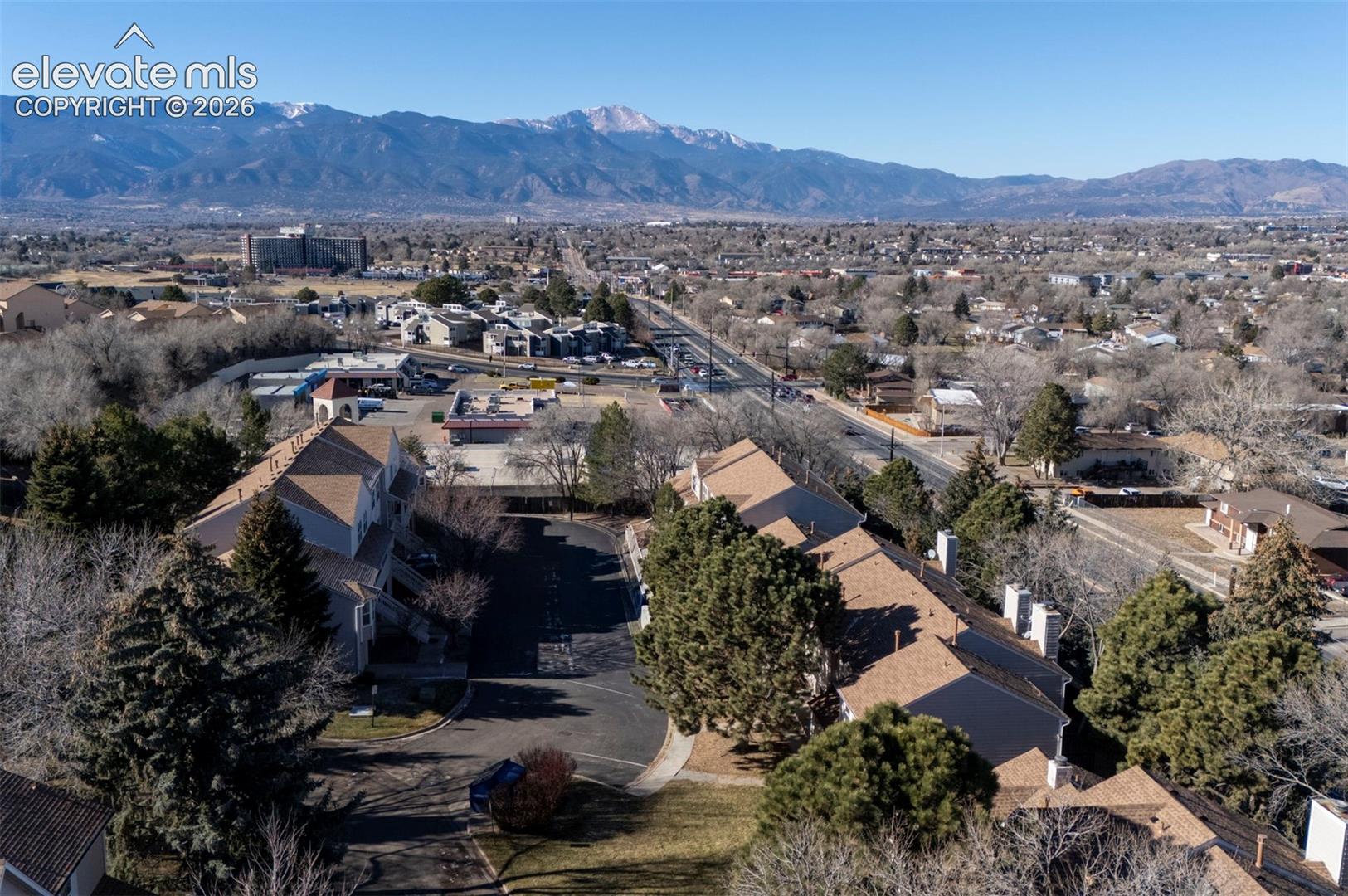 Aerial view of townhome complex and mountain views.