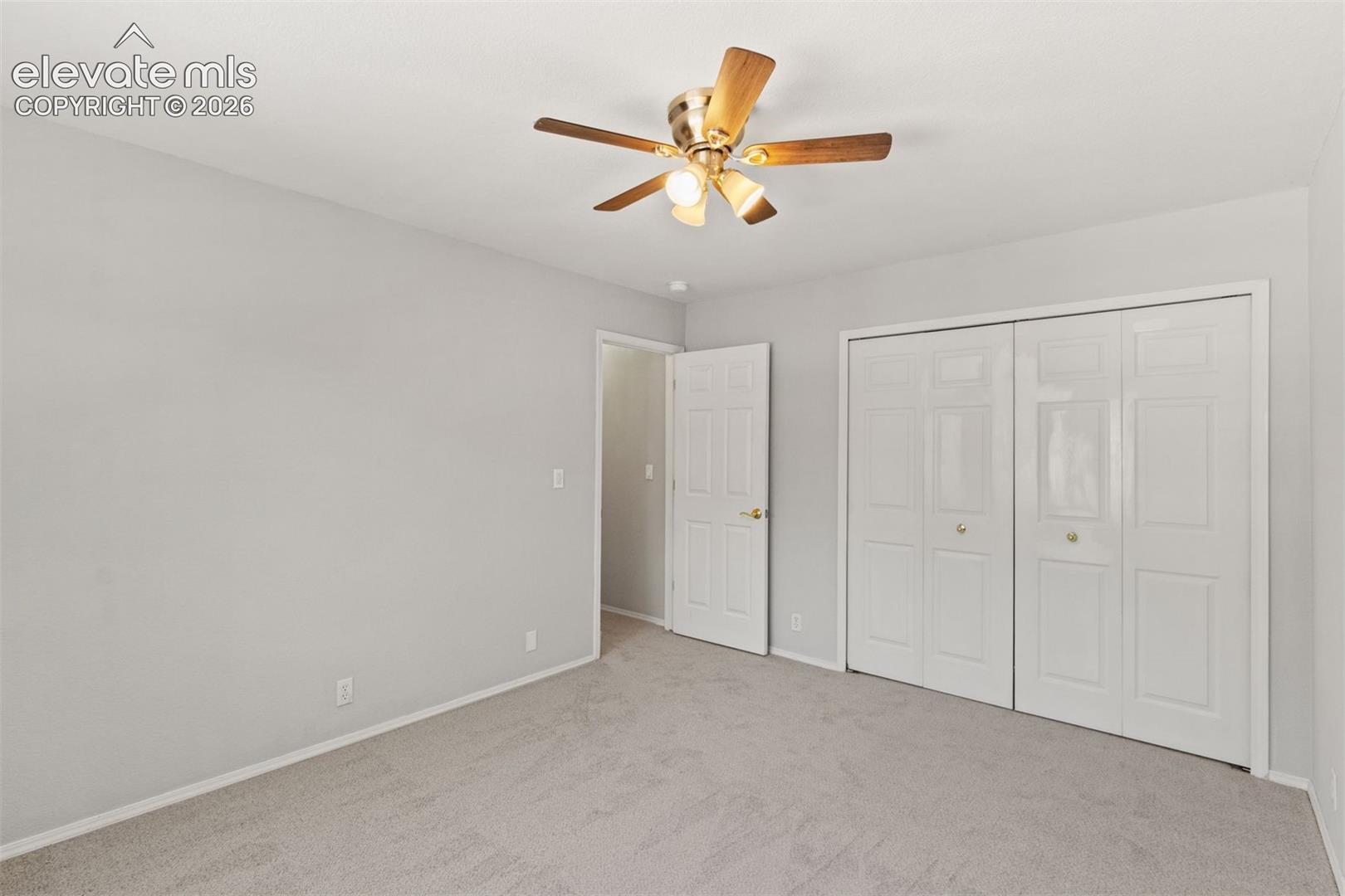 Upstairs bedroom with ceiling fan