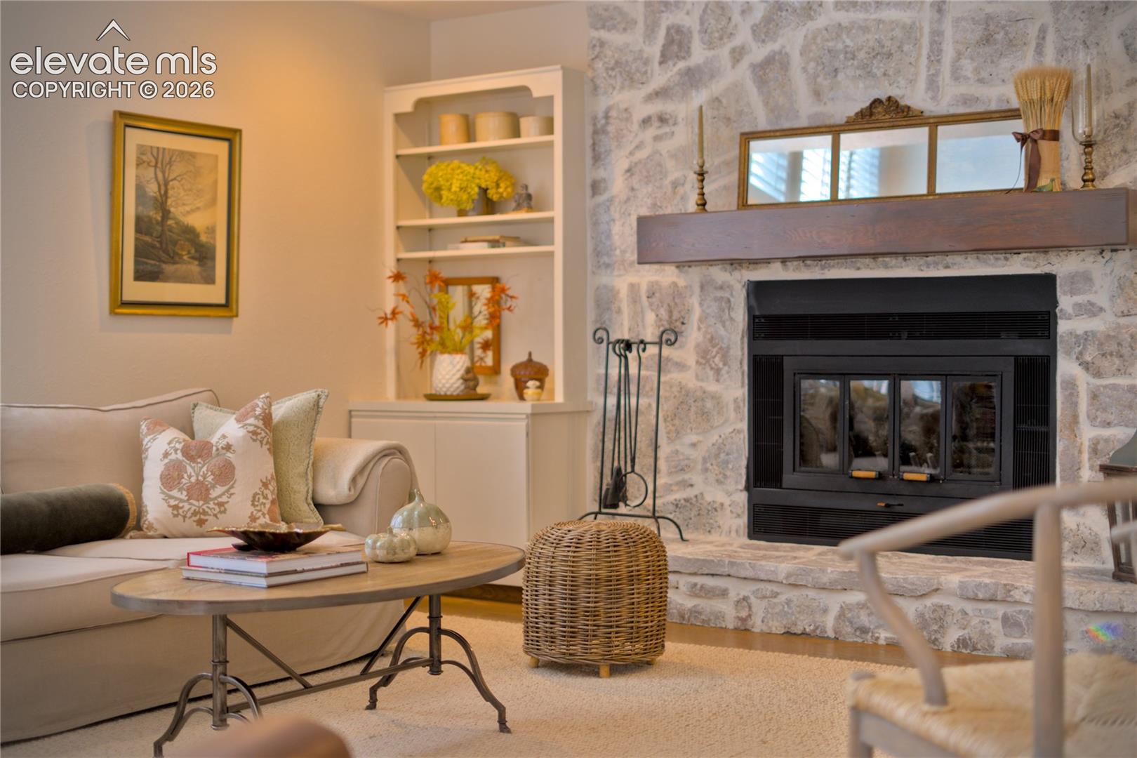 Natural stone adds texture + character to the great room's substantial wood-burning fireplace.