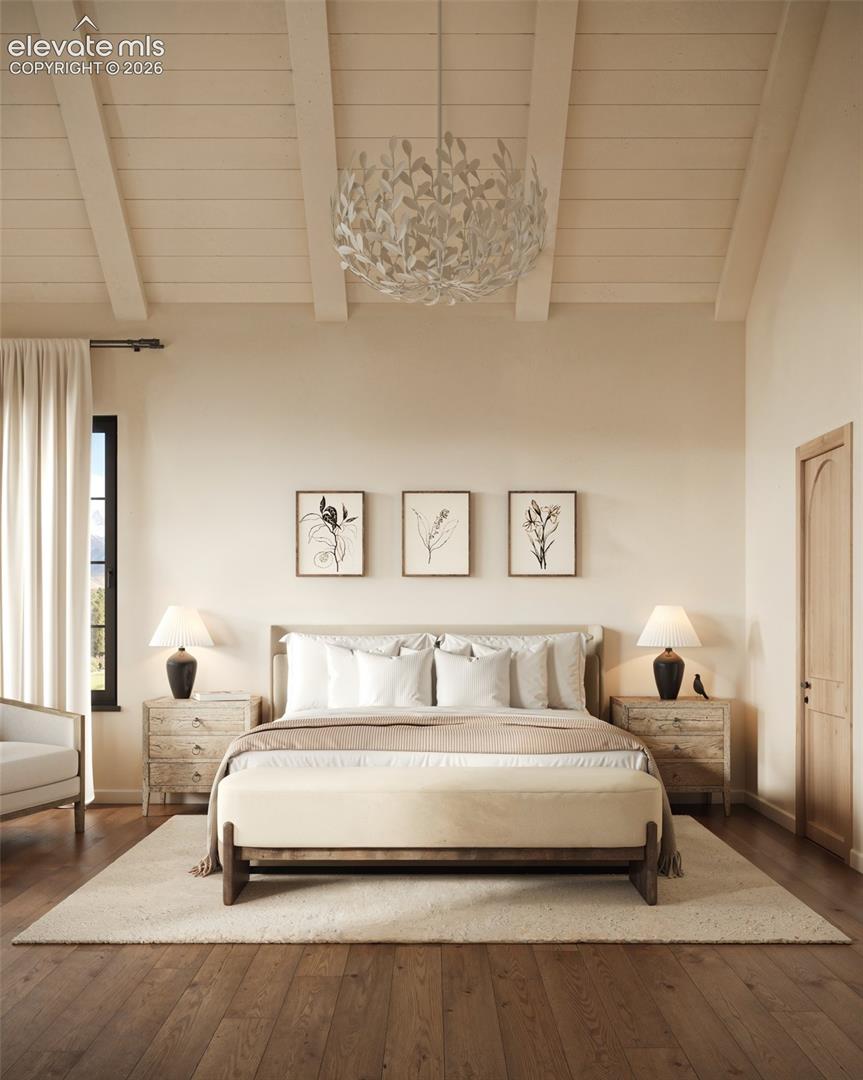 Vaulted ceiling with exposed wood-finish beams, dark wood-finish flooring, and an arched-top interior door