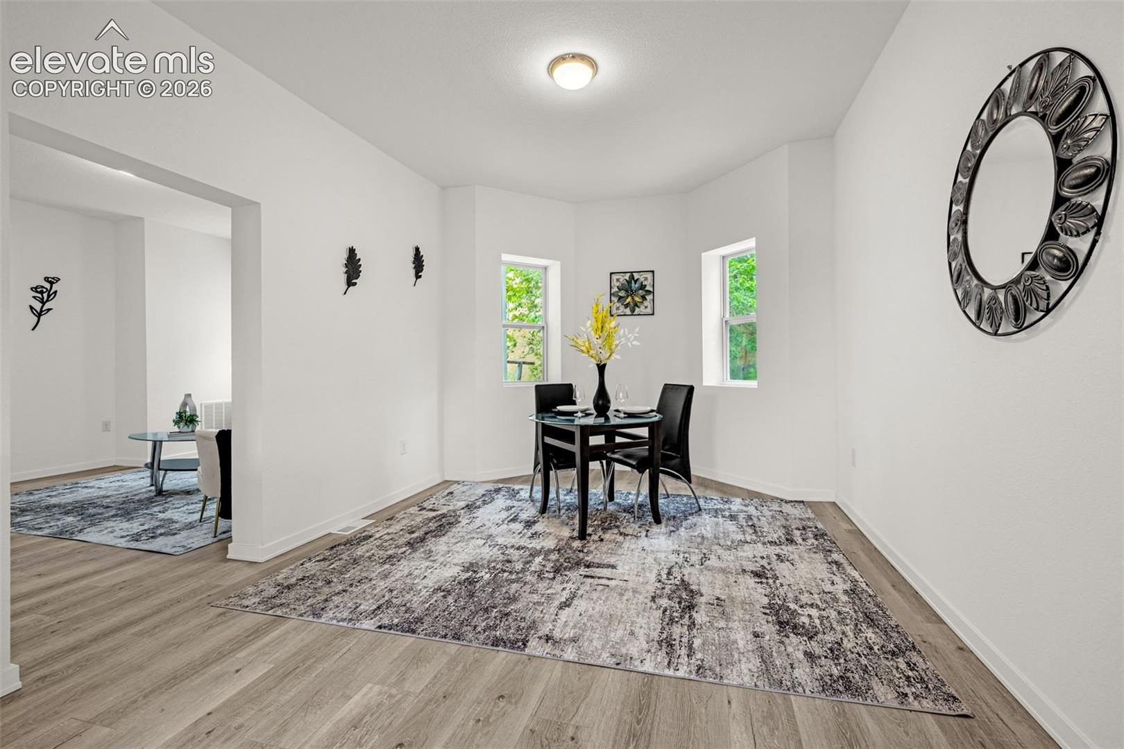 Dining area featuring wood-finish flooring and multiple windows