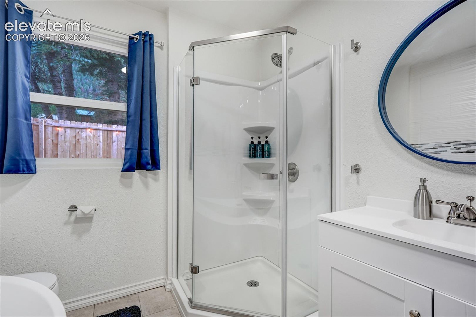 White vanity with an integrated sink and brushed nickel faucet