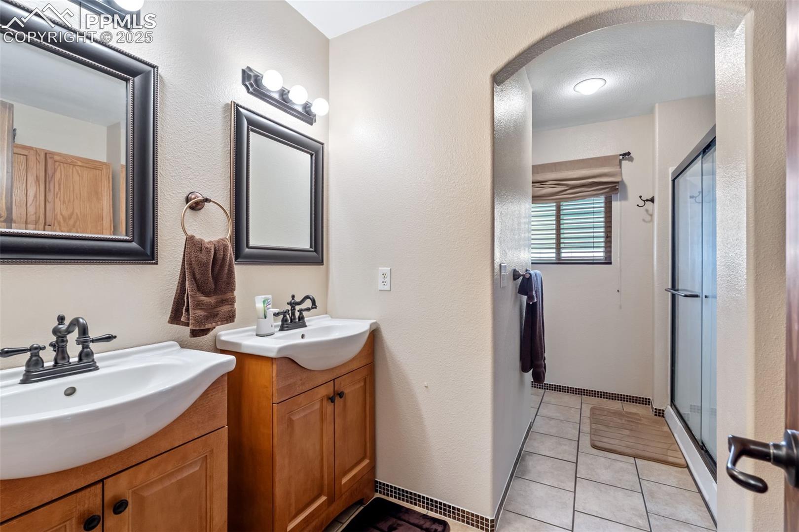 Updated full bathroom with modern vanity and lighting