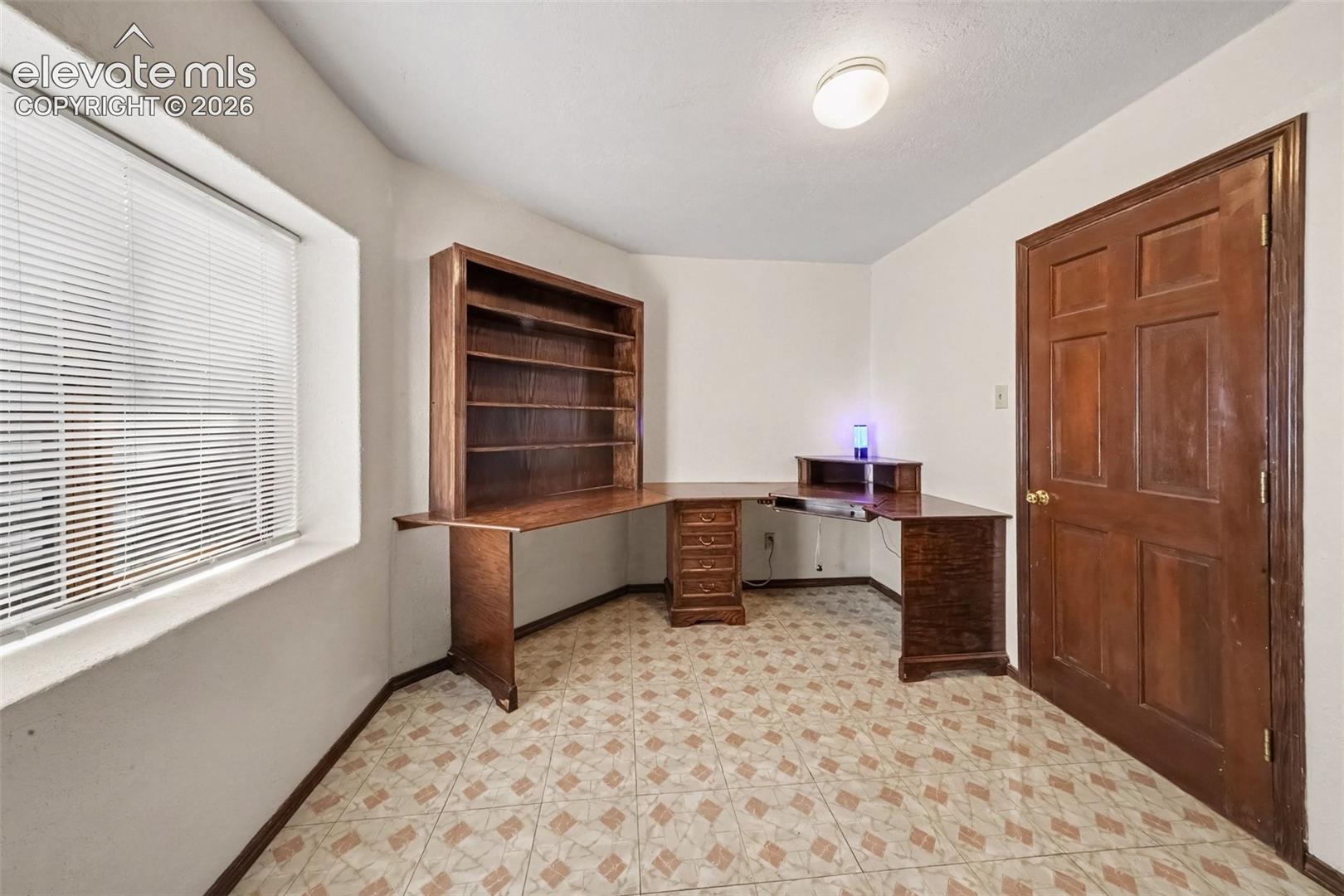Versatile basement office offers a quiet space for working from home, studying, crafting, or pursuing hobbies, with plenty of potential to customize it to your needs