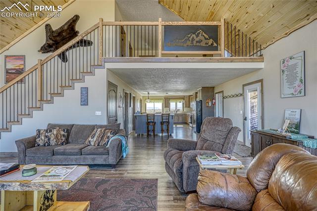 Living area featuring a vaulted wood ceiling and wood finished floors