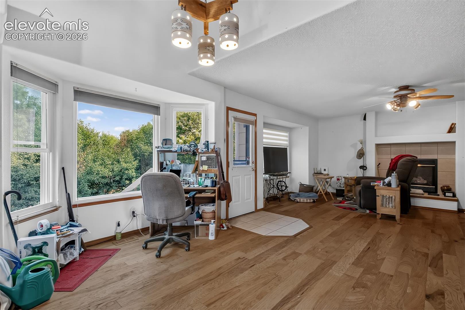 Dinning area with Bay windows, hardwood floors and walk-out to west facing deck.as  Seller has downsized and is using this area as his office