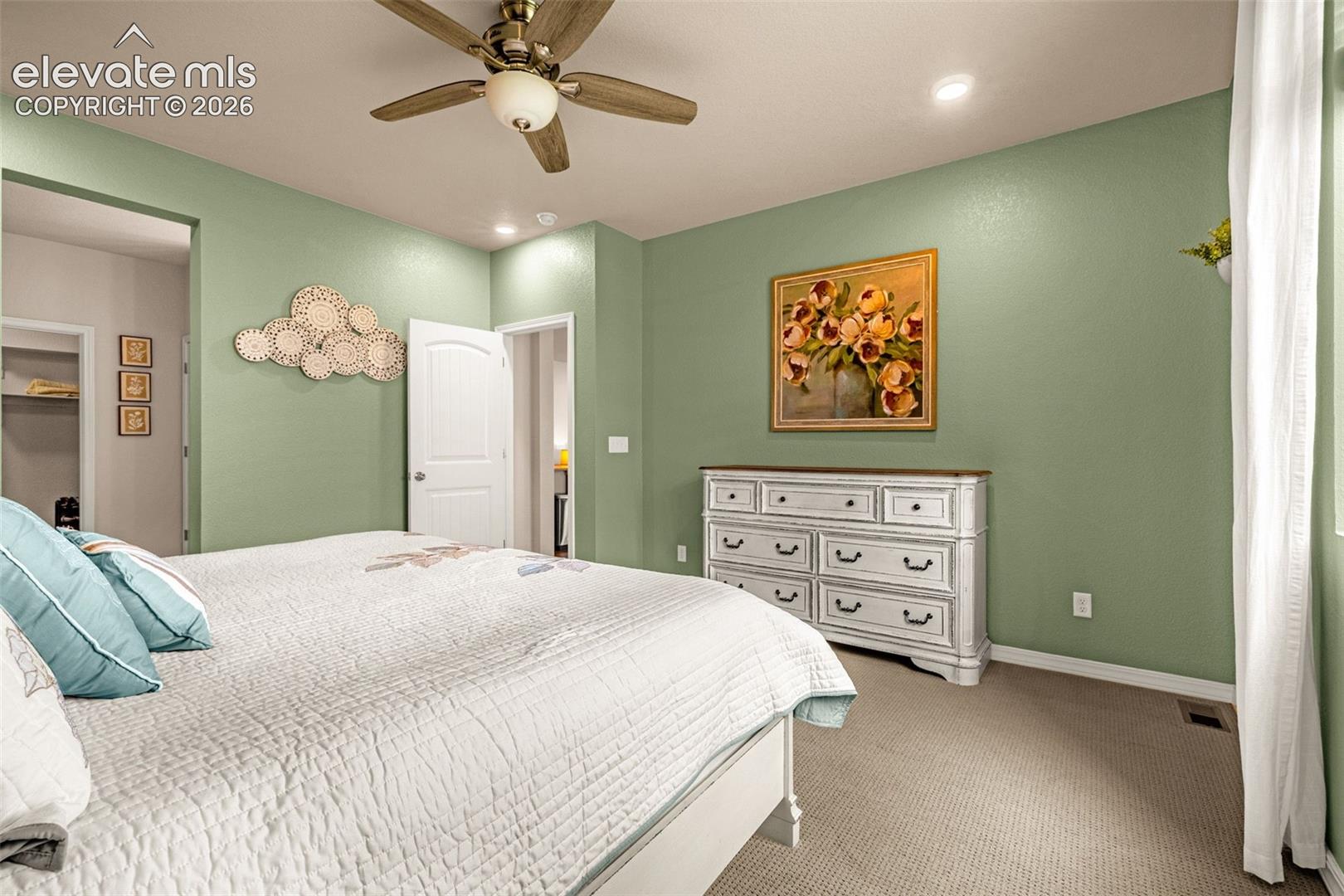 Recessed lighting, ceiling fan, carpeting, and a white interior door