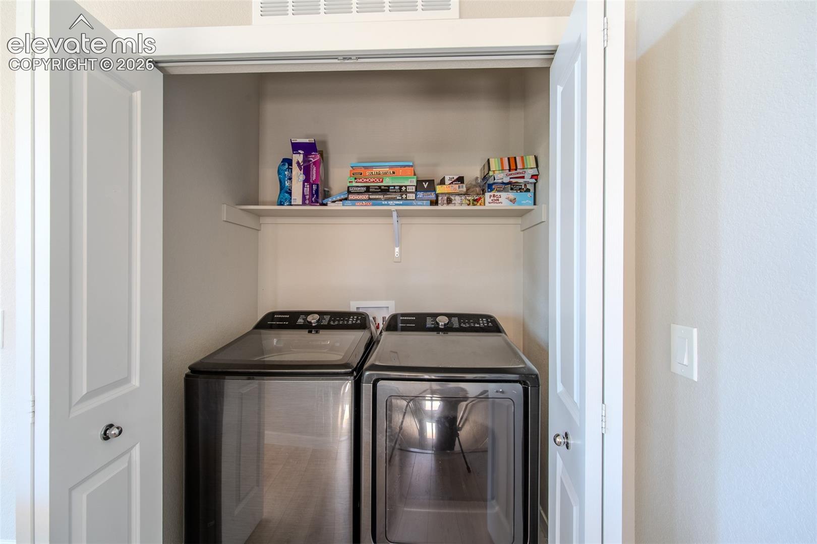 Upper Level Laundry Closet with built-in shelf and washer and dryer included.