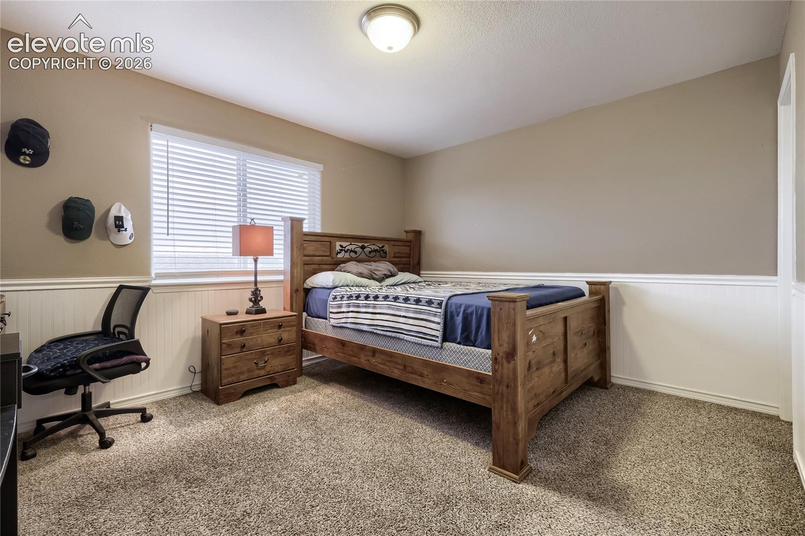 3rd upper-level bedroom room featuring Wainscoting and walk-in closet 