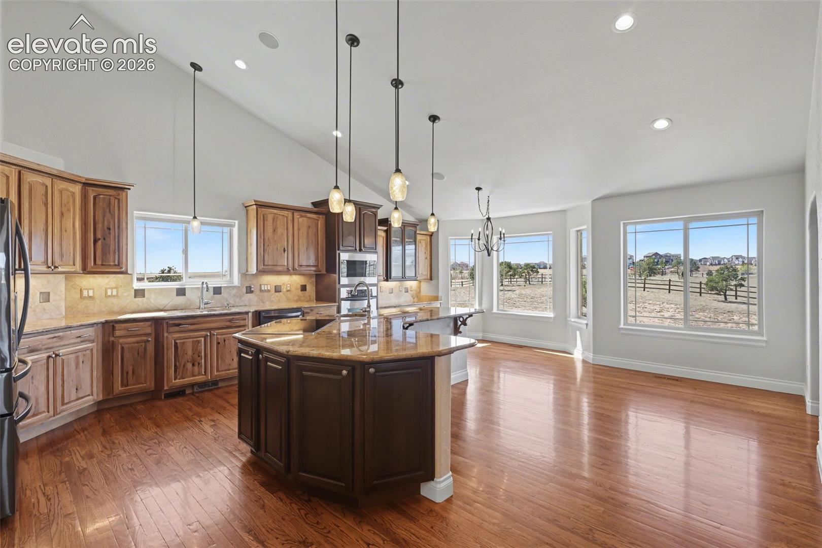 Gourmet Kitchen, Large Island, Granite Countertops, Stainless Steel Appliances, Solid Wood Floors, Pull Out Shelving,  Walk-In Pantry