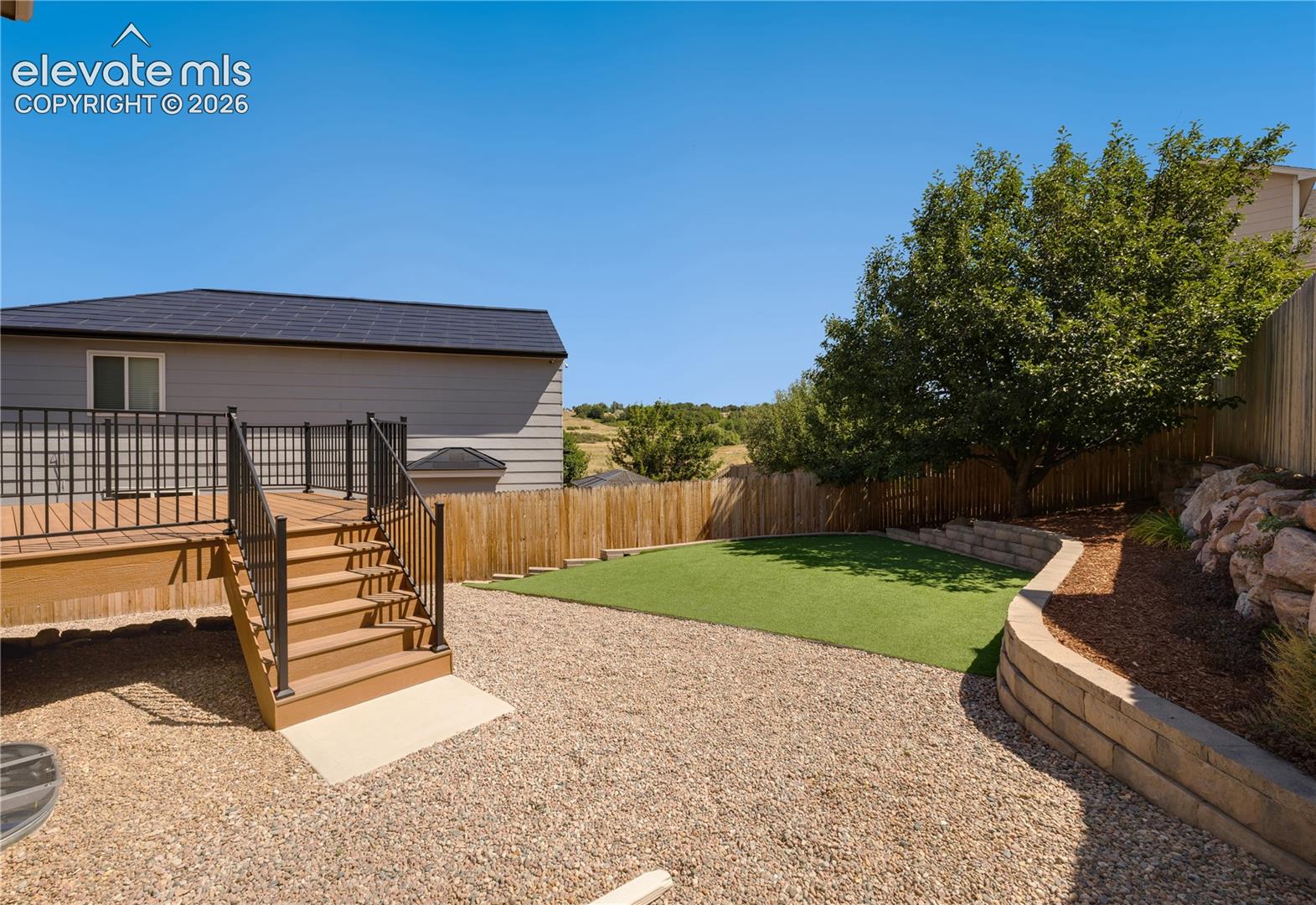 Backyard with view of Rampart Open Space, walk to trails, disc golf course, park, playground and baseball diamond