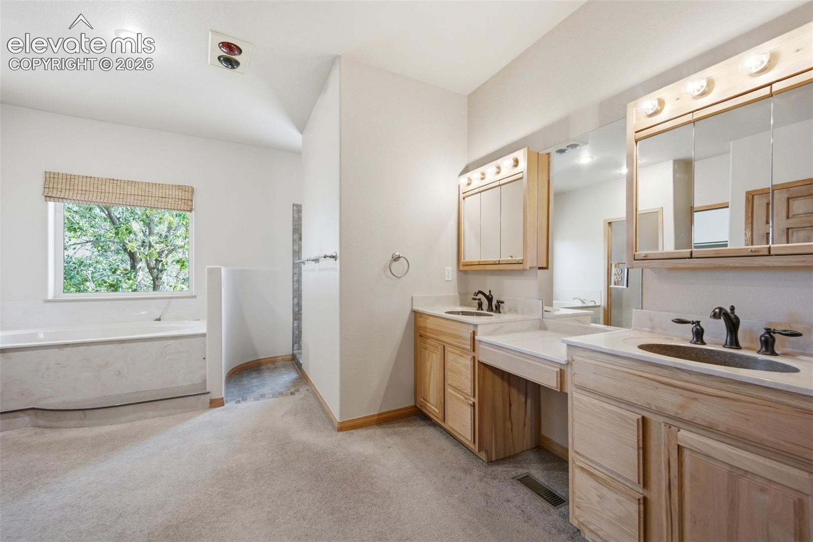 Dual Vanity, walk-in Primary Bath features walk-in shower and stand alone tub