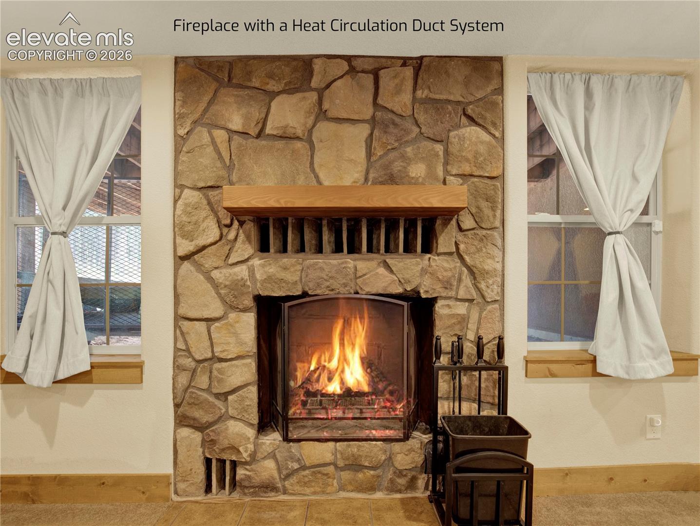 Large wood burning fire place that is uniquely designed with heat circulation piping to create more heat to go into the house instead of outside the flew