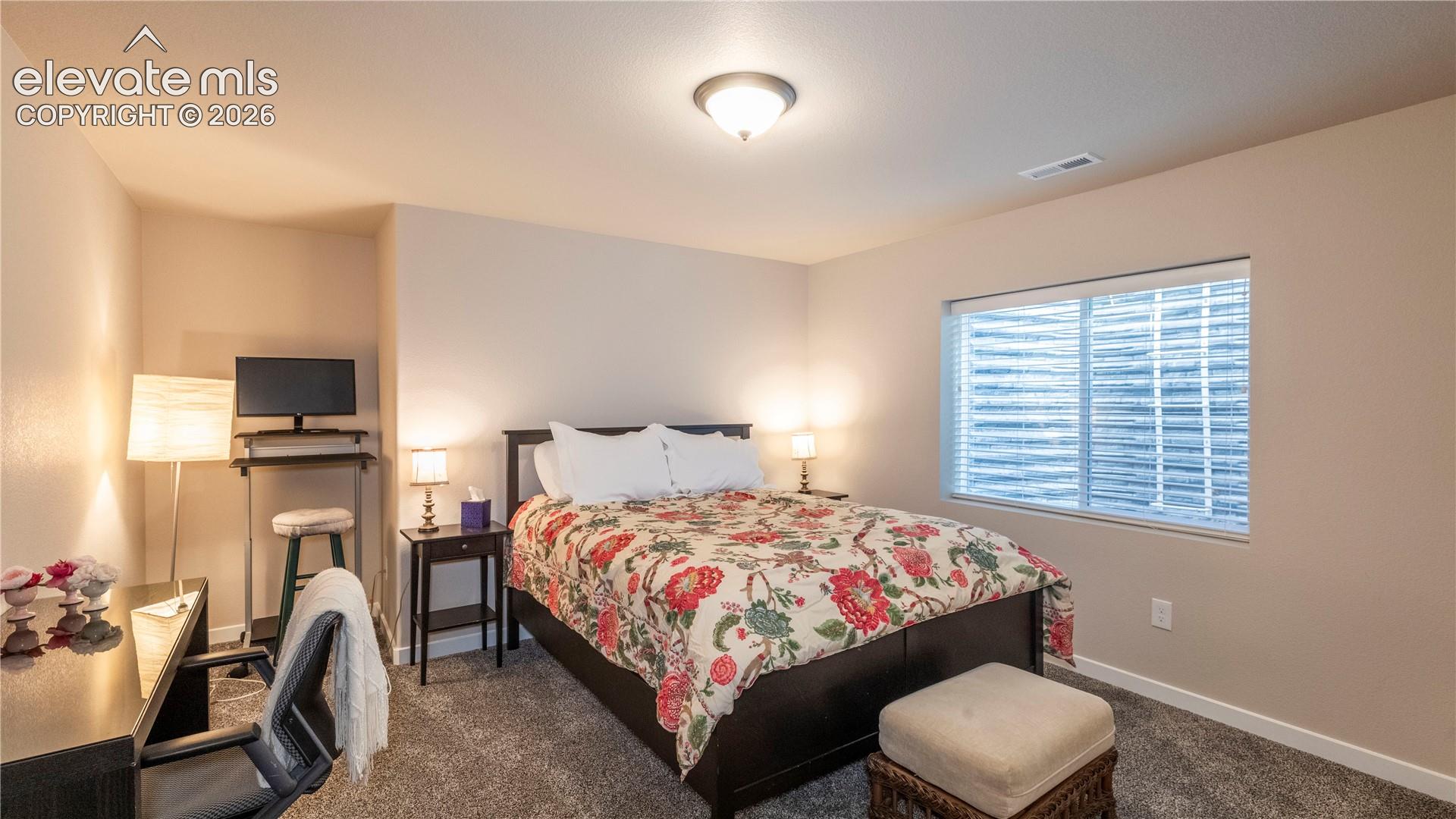 Spacious bedroom with sitting or study area