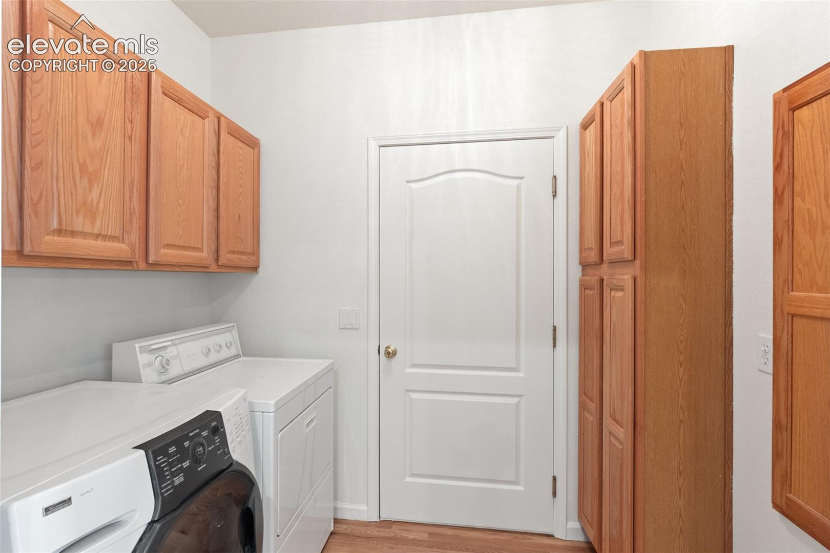 Main level laundry with storage and garage access