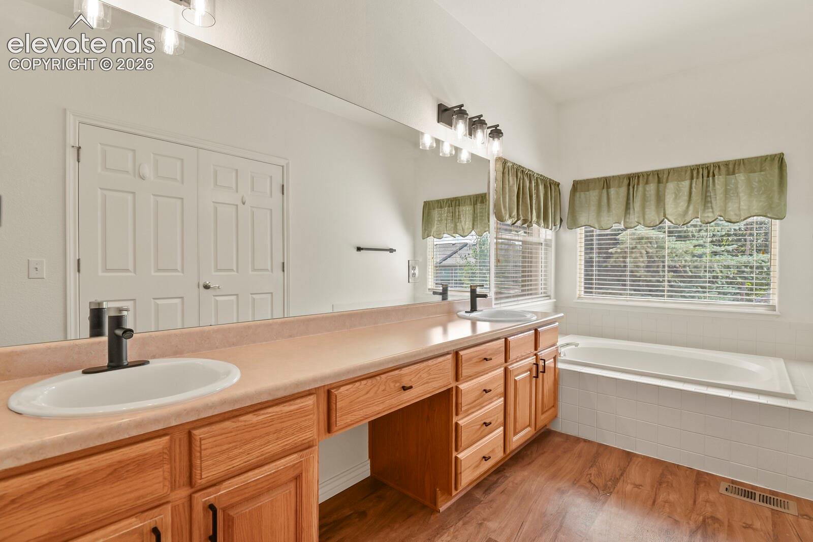 Primary Bath with new lighting and hardware! Double Sinks, Soaking tub and separate shower room!