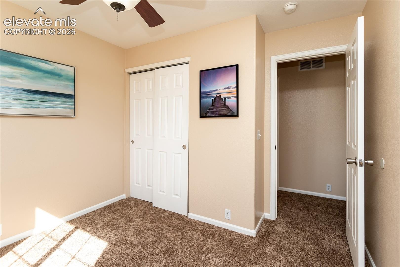 A third upper bedroom offers versatile living space with sliding door closet storage