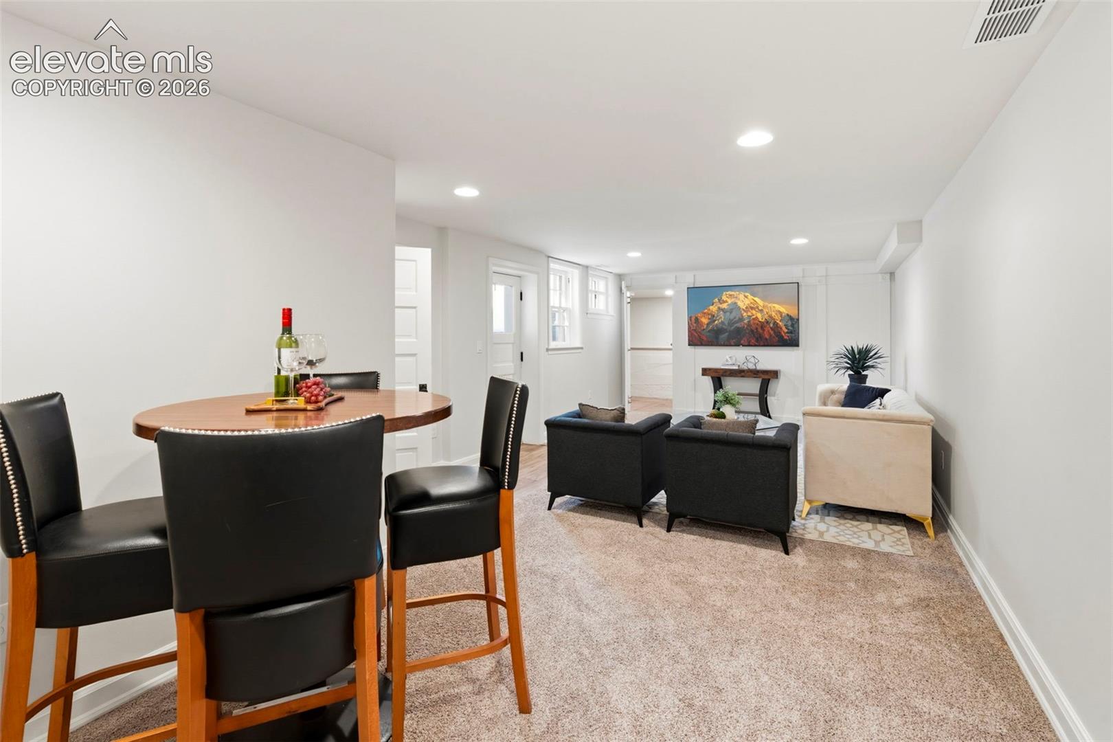 Neutral-toned walls, recessed lighting, and wall-to-wall carpeting