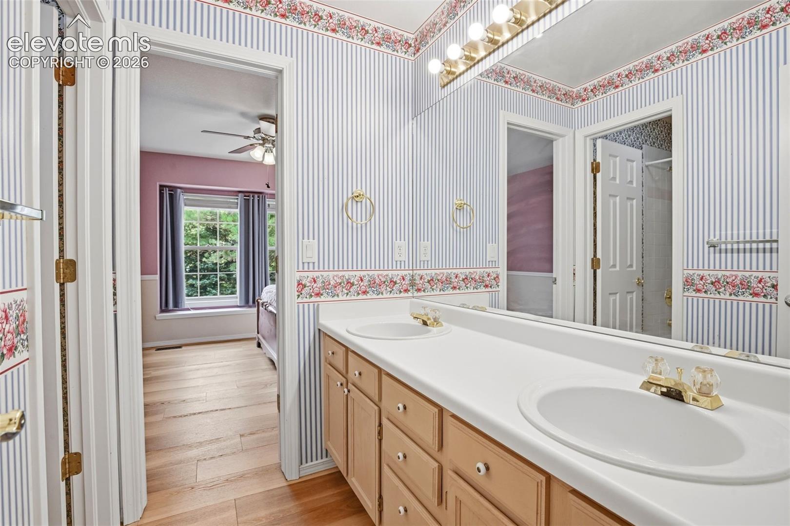 Full attached bathrom with dual sinks and separate tub/shower combo