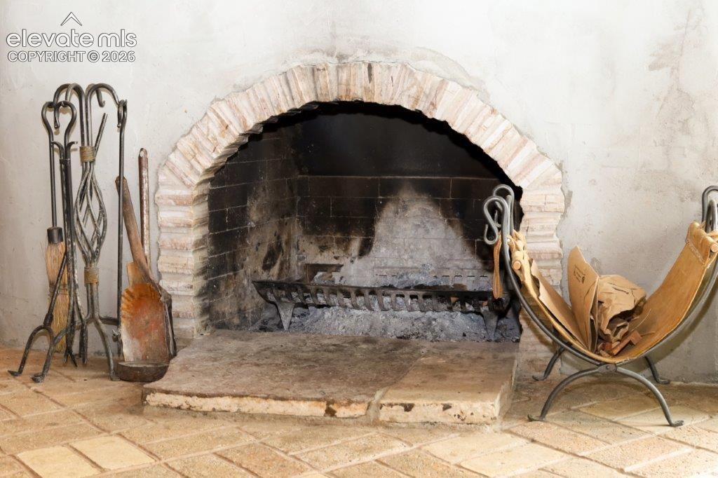Masonry fireplace with a brick arch and hearth