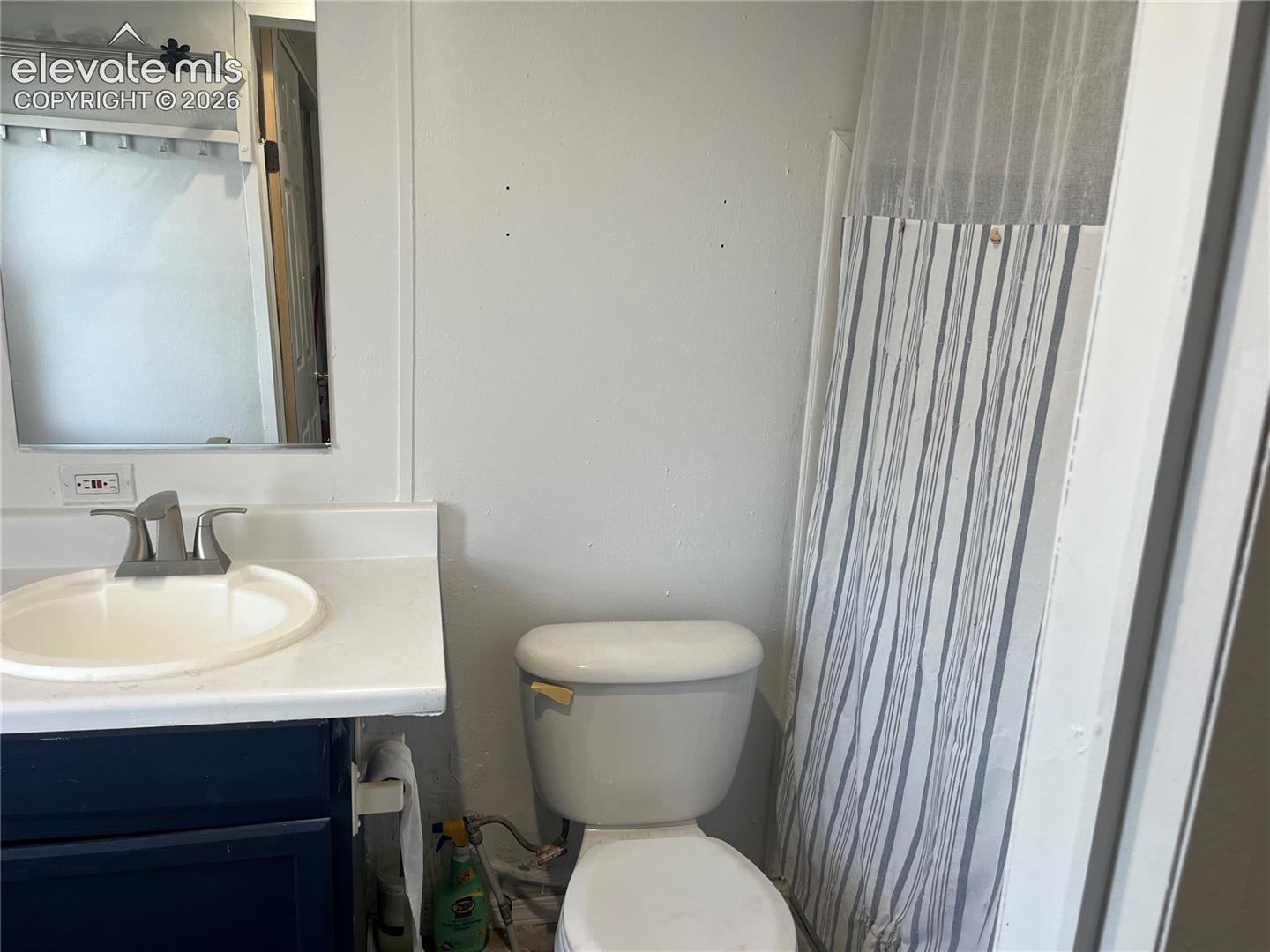 Bathroom vanity with integrated sink, brushed nickel faucet, and under-sink cabinetry
