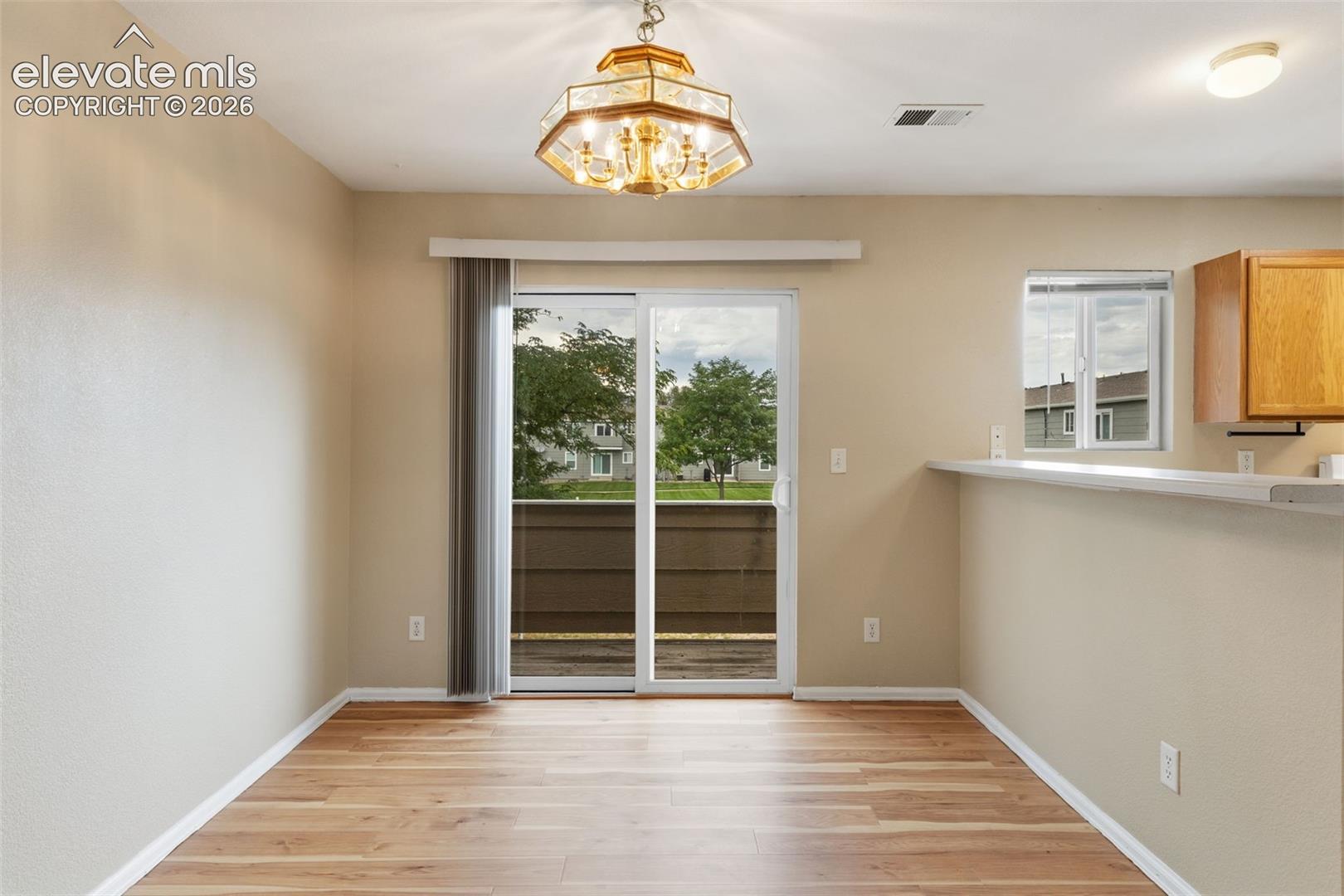 The Dining Area showcases a sliding glass door which provides access to the home's exterior private balcony!