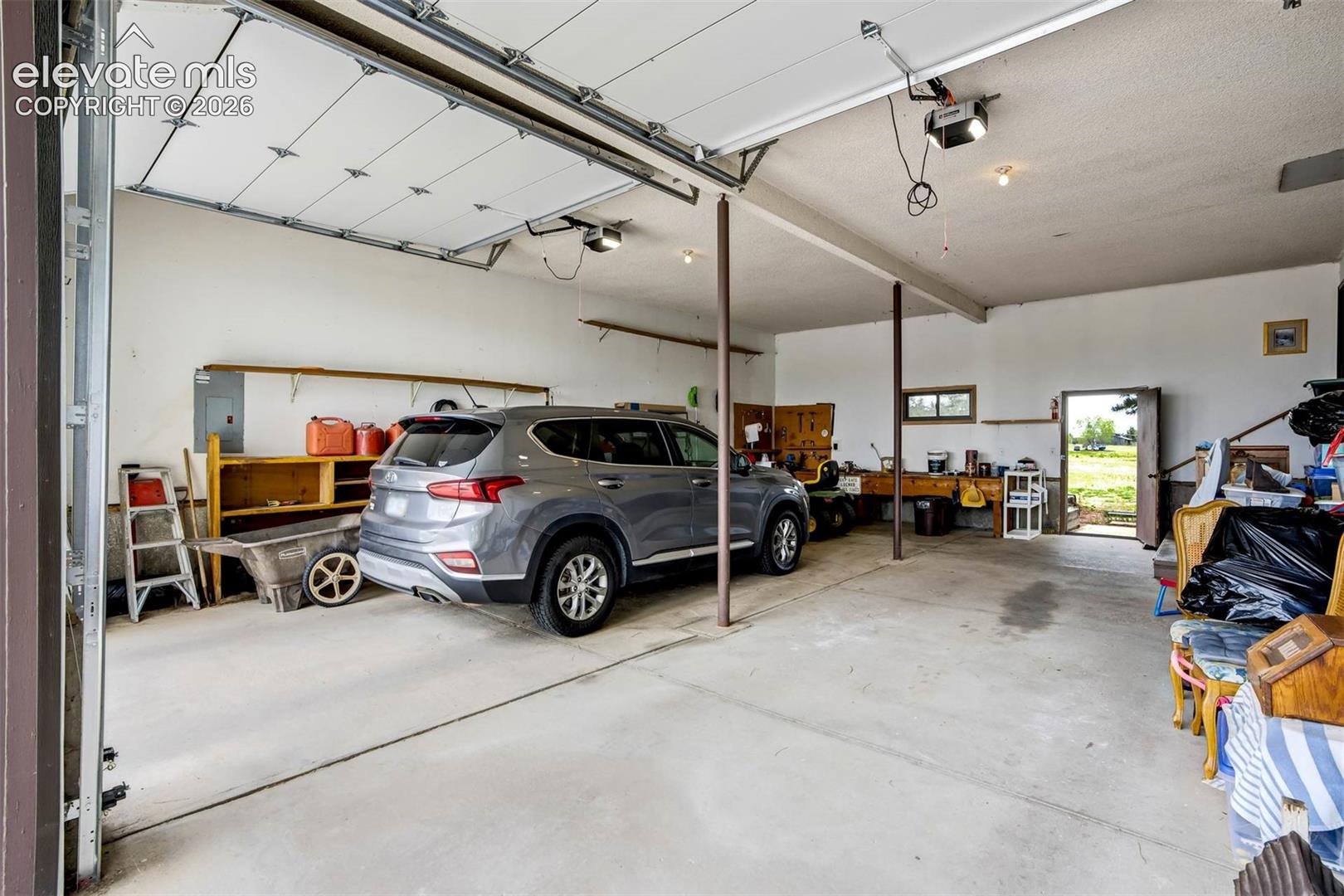 OVERSIZED, can fit 4 cars 2 on each side. Tall garage doors measure 9'10" x 8'8" each.