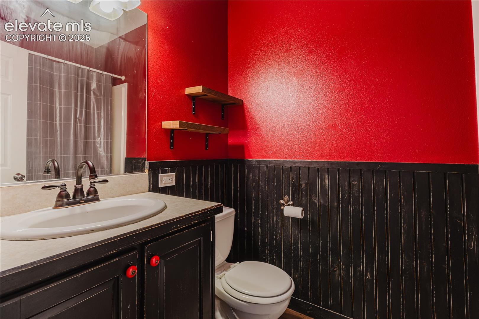 Built-in vanity with a single basin sink and bronze-finish faucet