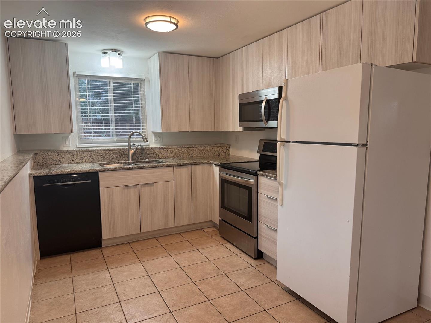 Lower level kitchen with ample cabinets and stainless steel appliances