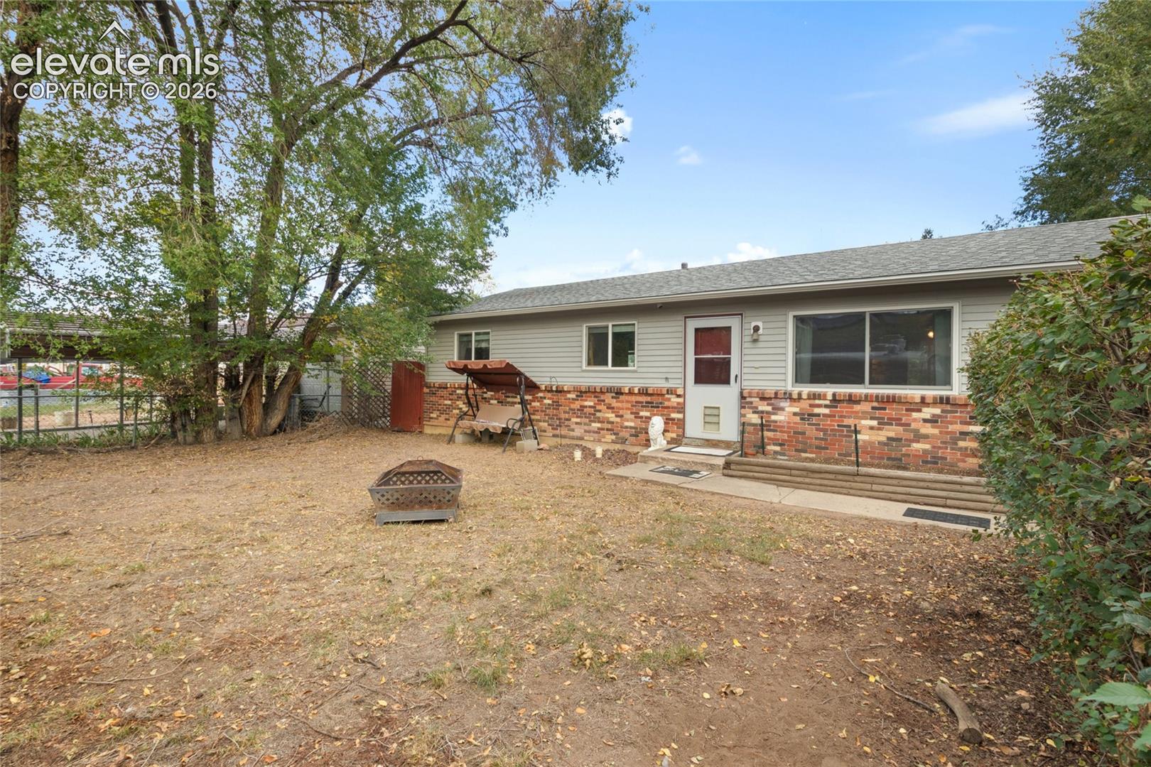 Fully fenced in front yard with hedges for privacy