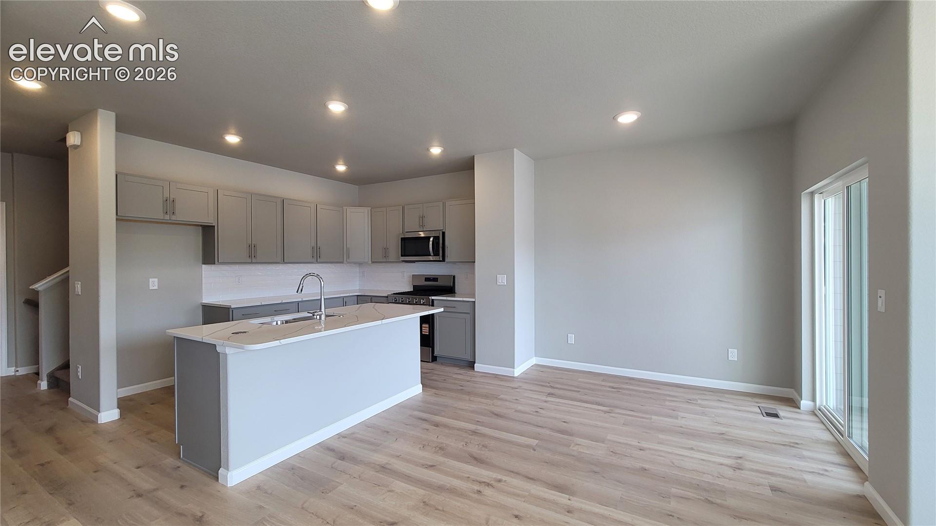 Dining area with LVP flooring and walks out to composite deck! 